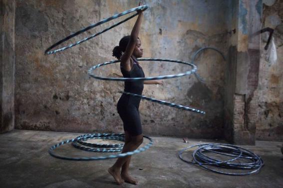 Girl performs with hoops during a training session at a circus school in Havana
