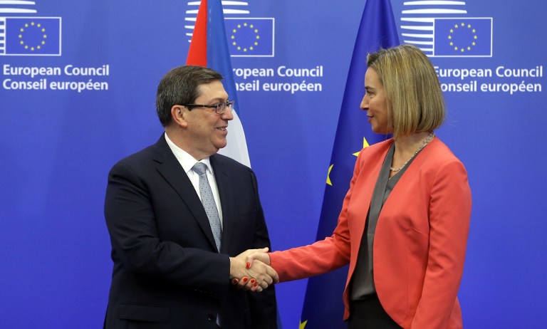 EU High Representative for Foreign Affairs Federica Mogherini (R) welcomes Cuban Foreign Minister Bruno Rodriguez Parrilla at the start of an EU-Cuba political dialogue and cooperation agreement in Brussels on December 12, 2016. / AFP PHOTO / EMMANUEL DUNAND