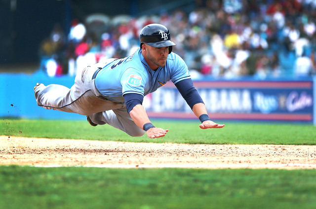 HAVANA, CUBA - MARCH 22:  Tampa Bay Rays Steve Pearce dives safely into third base during the exhibition game between the Cuban national team and the Tampa Bay Rays of the Major League Baseball at the Estado Latinoamericano March 22, 2016 in Havana, Cuba. U.S. President Barack Obama attended the game after becoming the first sittng president to visit Cuba in 88 years.  (Photo by Joe Raedle/Getty Images)