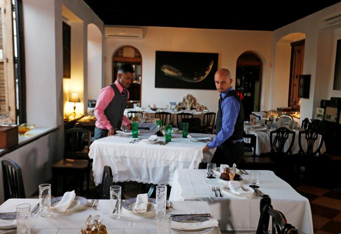 Waiters get tables ready in the Atelier restaurant in Havana, Cuba, November 27, 2016. REUTERS/Stringer