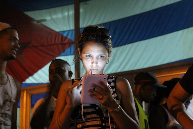 Oct. 16, 2015 - Havana, Cuba - A young woman surfs the Internet at a public wifi spot in the district of Marianao in Havana, Cuba, 16 October 2015. Public wifi spots ensure enthusiasm amongst young people in Havana. With limited offerings, the Castros want to cautiously lead the previously isolated island into the online world. Photo:Â ISAACÂ RISCO/dpa (Credit Image: © Isaac Risco/DPA via ZUMA Press)