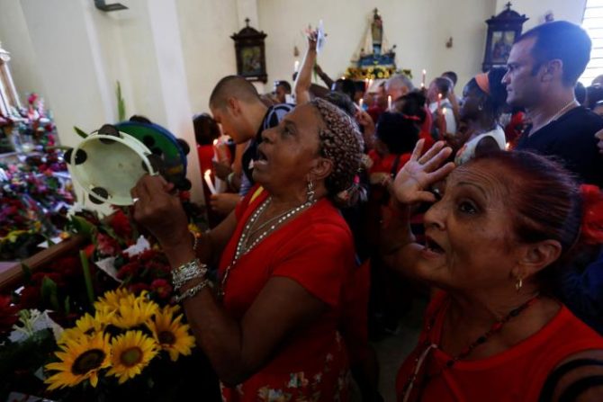 People gather at the Saint Barbara Church to pray on the day known as Santa Barbara to Catholics and Chango to followers of Cuba's Santeria religion, in Havana, Cuba, December 4, 2016. REUTERS/Stringer
