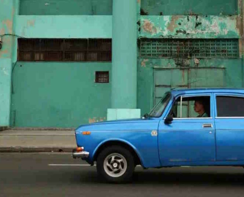 Cuban drivers of state-owned cars have to take people at bus stops
